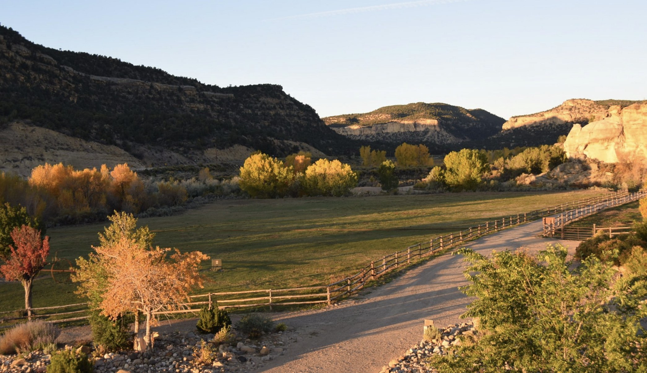 A fenced ranch pasture with fall foliage and canyon cliffs near Boulder Utah