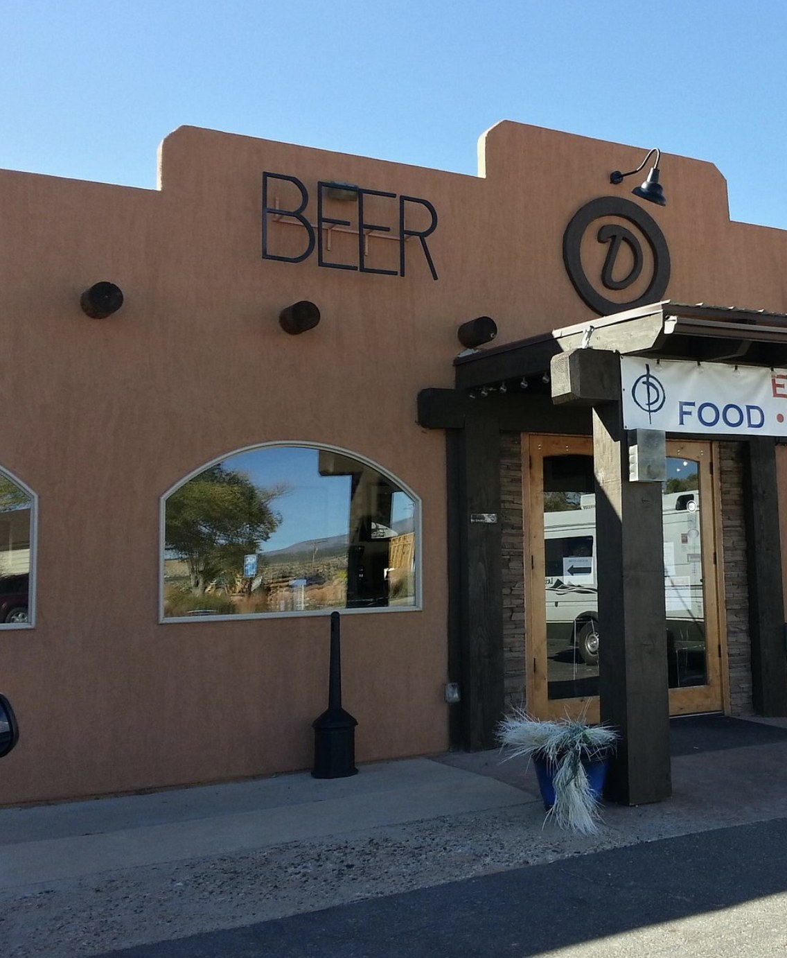 The BEER sign and circular D logo on the exterior of Circle D Eatery in Escalante