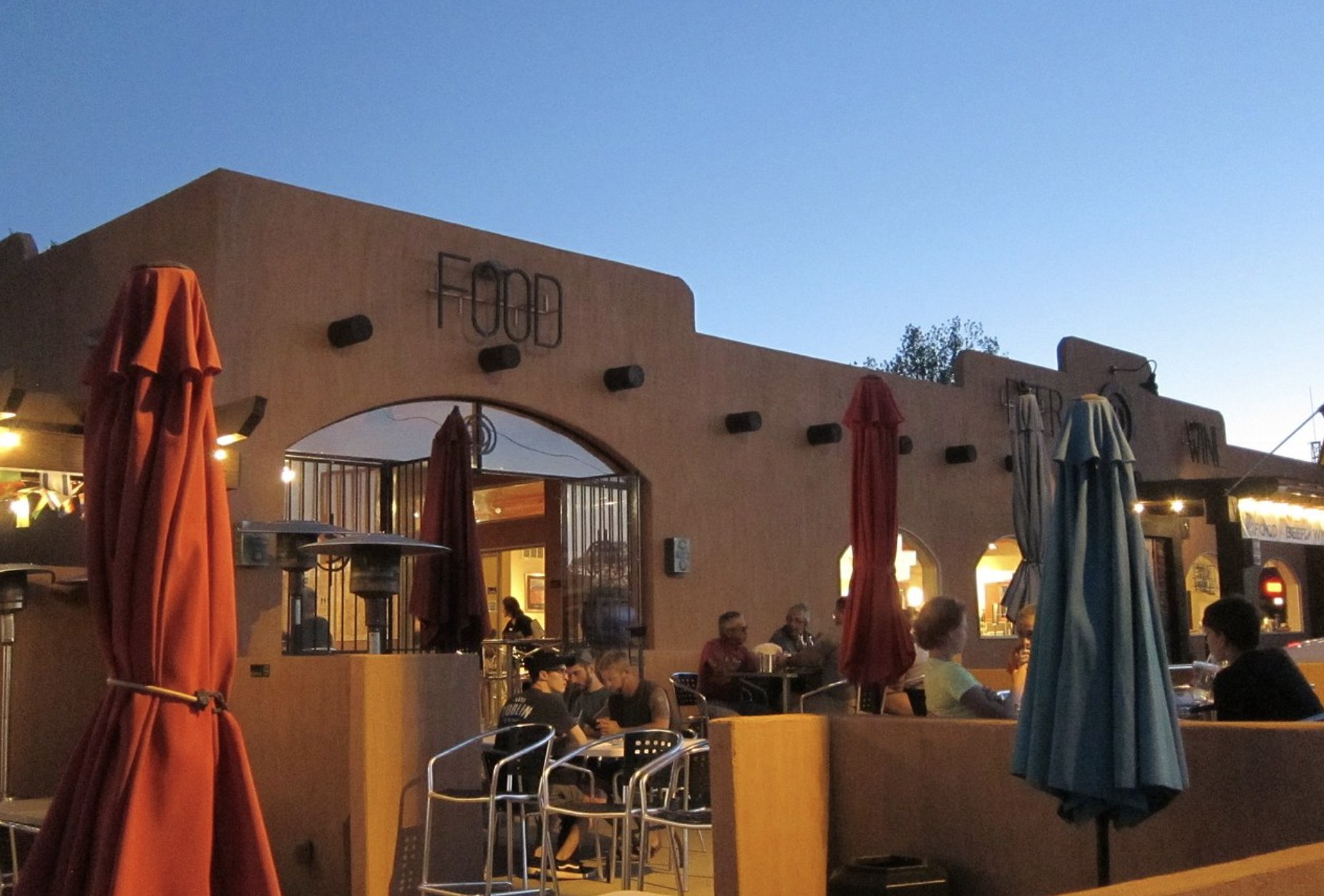 Diners seated on the patio at Circle D Eatery in Escalante at dusk