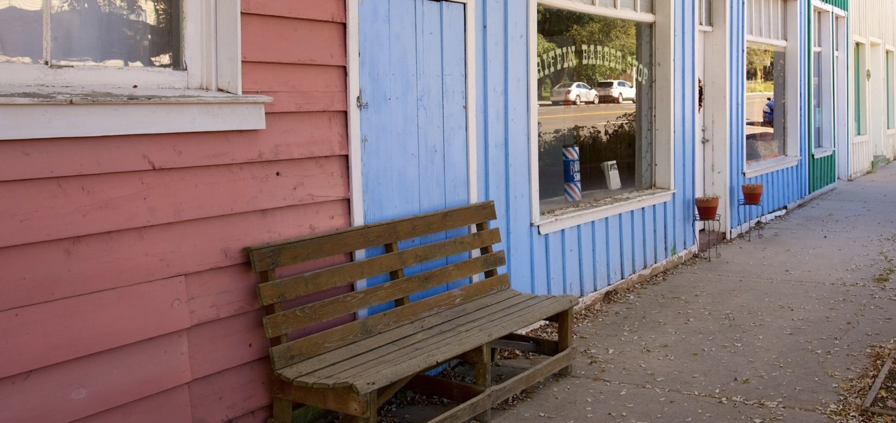 Griffin Barber Shop storefront with a wooden bench on Main Street in Escalante Utah
