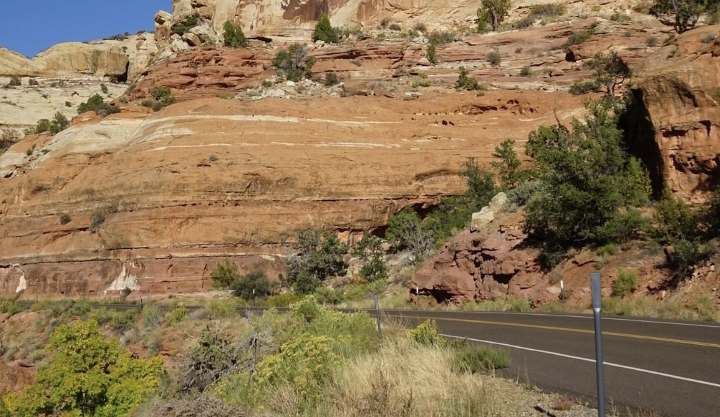 Layered red rock cliffs along the shoulder of Scenic Byway 12 near Escalante
